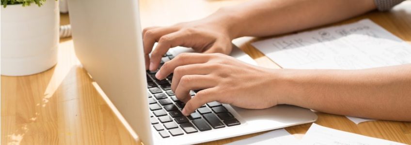 Image of a man learning how to write with AI with his laptop